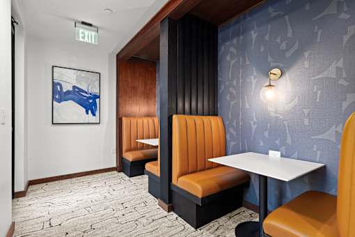 A restaurant interior with a blue wallpaper and a white table.