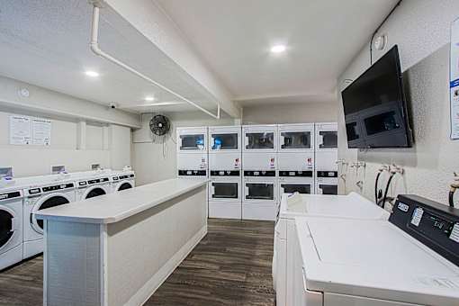 A laundry room with washers and dryers.