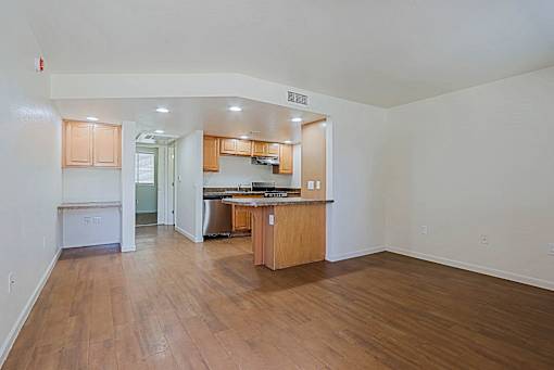 A kitchen with wooden cabinets and a countertop is visible.