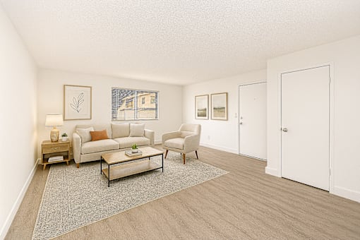 A living room with a couch, chair, and coffee table.
