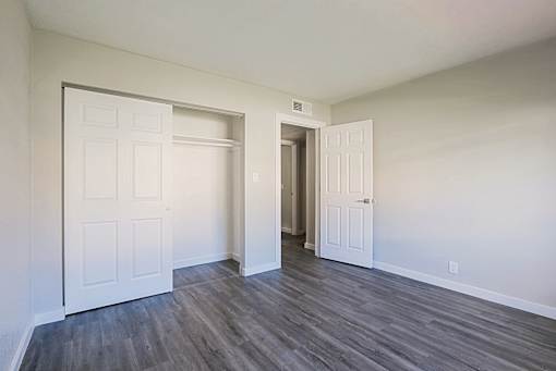 A room with a white door and a white wall.