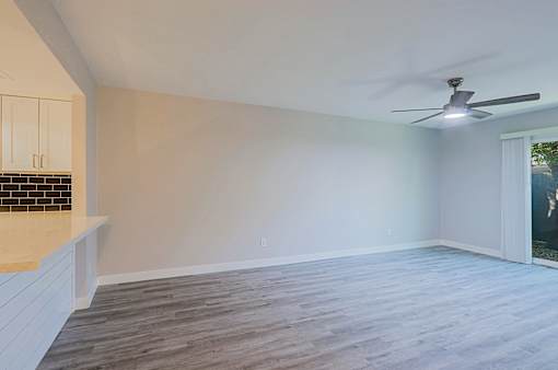 A room with a ceiling fan and a window.
