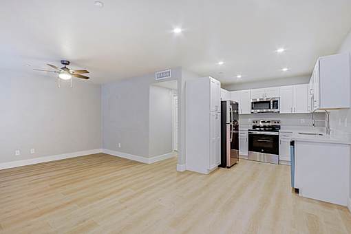 a renovated kitchen with white cabinets and stainless steel appliances