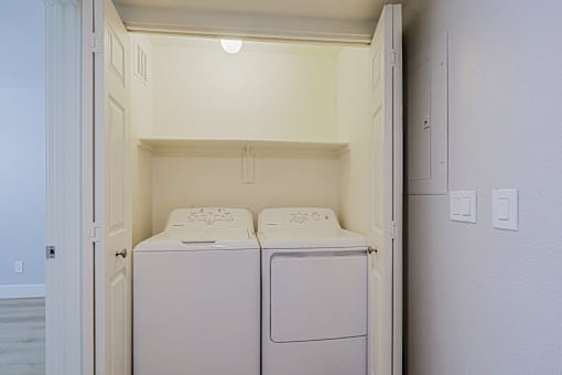 a washer and dryer in a laundry room with white walls