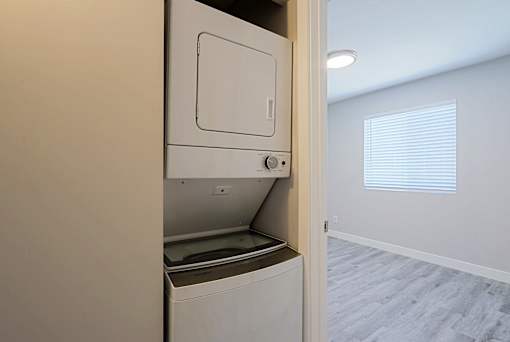 A white dishwasher is built into a kitchen wall.