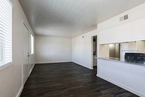 A room with a white ceiling and wooden floors.