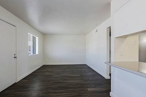 A room with wooden floors and white walls.