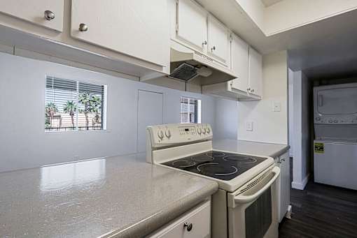 A white kitchen with a stove and oven.