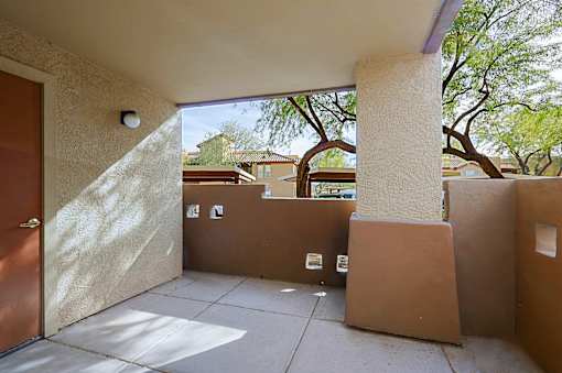 A sunny day at the courtyard with a brown door.