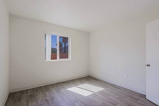 A room with a window and a door.