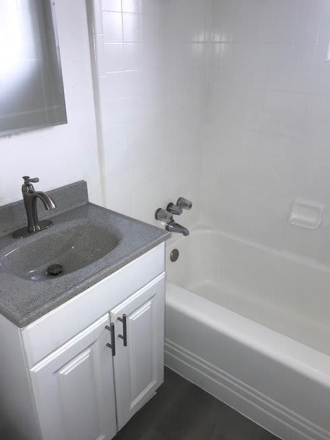 a bathroom with a sink and a bath tub