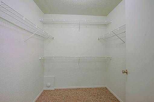 Empty room with white walls and shelves.