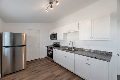 a kitchen with stainless steel appliances and white cabinets