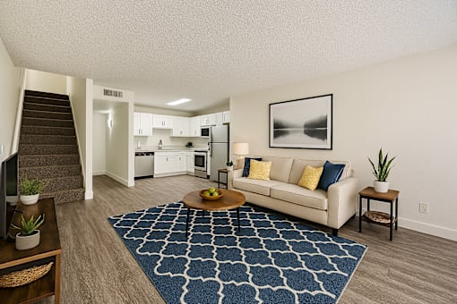 A living room with a couch, a coffee table, and a rug.
