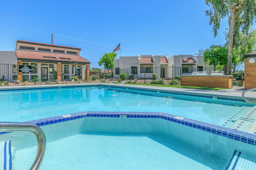 a large swimming pool with apartments in the background at Tides on Southern, Mesa, 85204