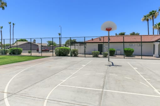 an outdoor basketball court in front of a house with a basketball hoop at Tides at Mesa, Mesa, 85204