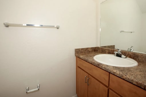 A bathroom with a sink and a mirror.
