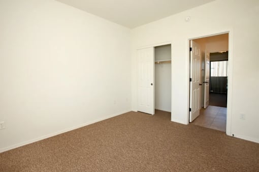 A room with carpeted floor and white walls.