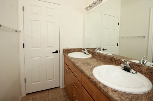 A bathroom with a sink and a mirror.