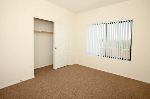 A room with a brown carpet and a white door.