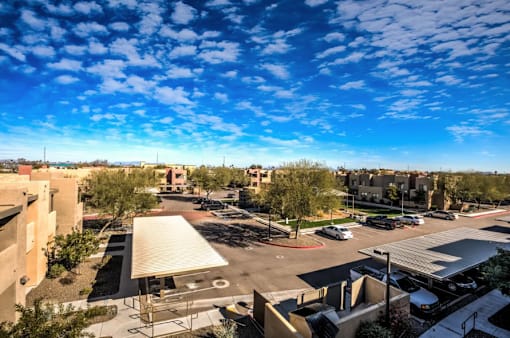 A parking lot with cars and a building in the background.