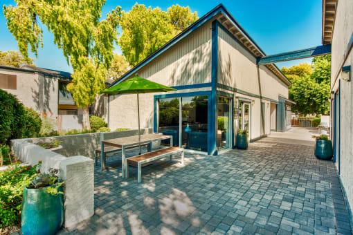 a patio with a table and benches outside of a building at Connect on Northern, Glendale, AZ 85301