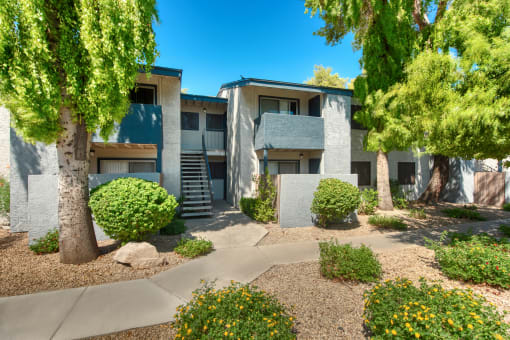 an exterior view of a building with trees and shrubs at Connect on Northern, Arizona, 85301