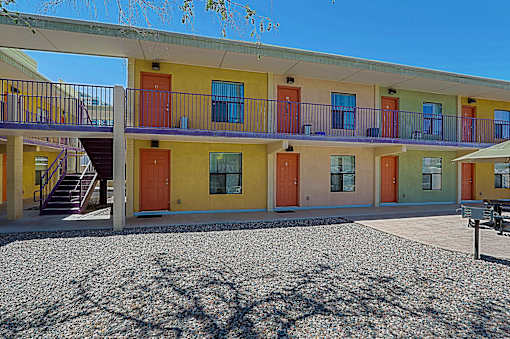 A building with yellow, orange, and green doors.