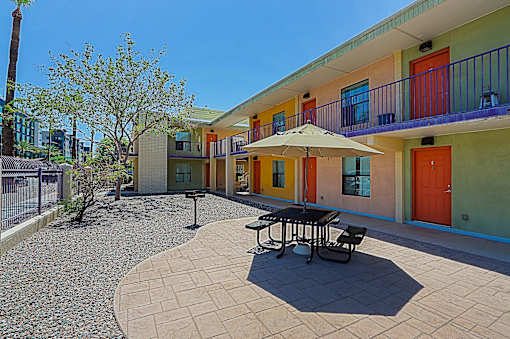 A sunny day at the colorful courtyard with a table and chairs.
