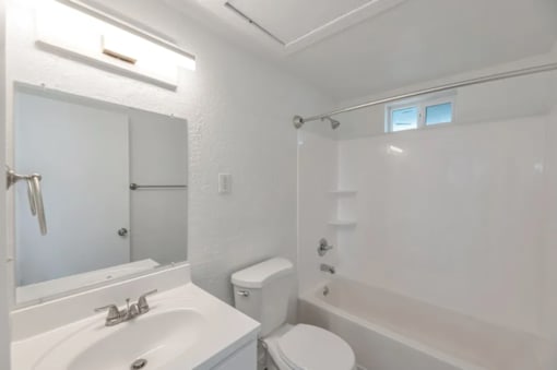 a bathroom with a sink toilet and a shower