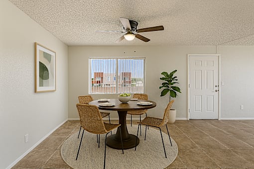 A dining room with a table set for four.