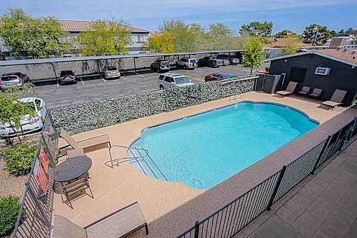A small pool with a table and chairs.