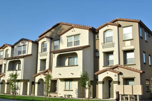 a row of town houses with trees in front of them