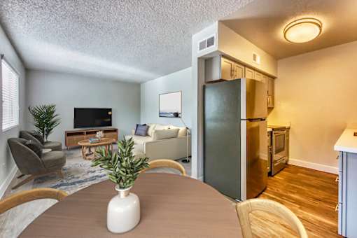 A living room with a grey couch and a wooden coffee table at Gilbert Square Apartments, Mesa, AZ 85203