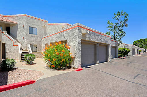 A row of houses with a red curb in front.
