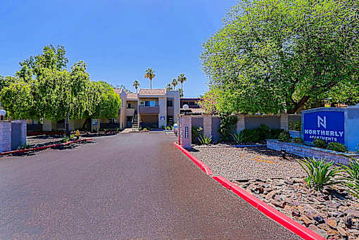 The image shows a sunny day at the entrance of a residential complex named NORTHERLY.
