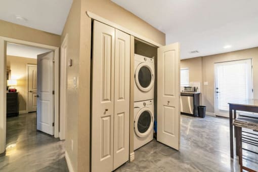 a washer and dryer in a laundry room with doors