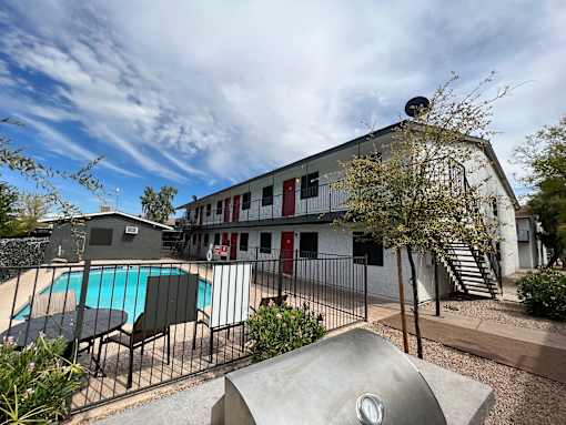 A large building with a pool in front of it.