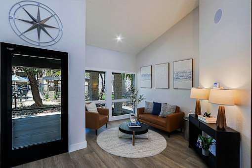 A living room with a couch, a coffee table, and a lamp.