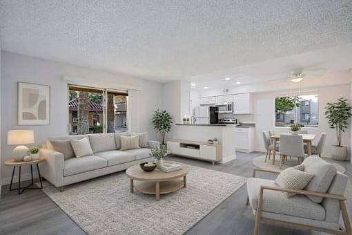 A modern living room with a grey sofa, wooden coffee table, and a grey armchair.