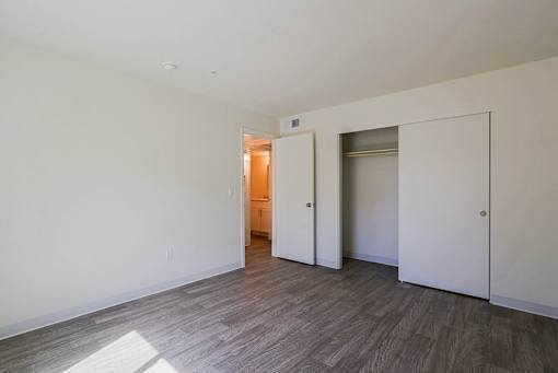 A room with a wooden floor and white walls.