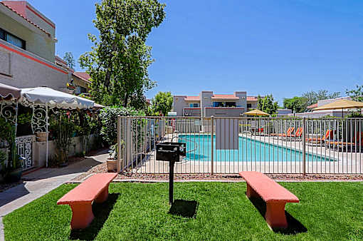 A pool area with a bench and a mailbox.