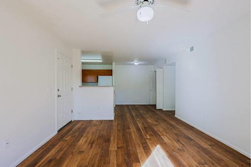 A room with wooden floors and white walls.