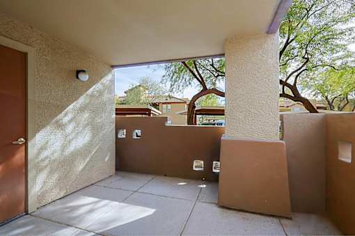 A sunny day at a courtyard with a brown door.