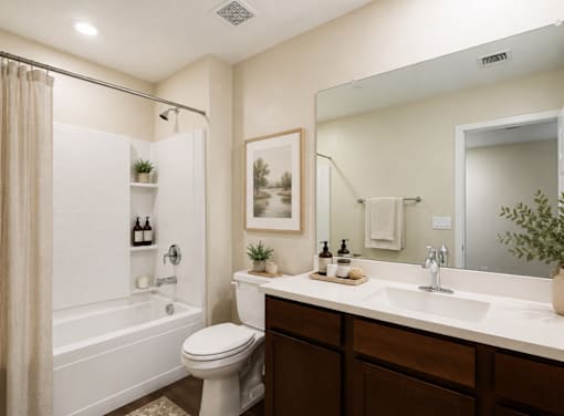 A bathroom with a white toilet, a white sink, and a white bathtub.
