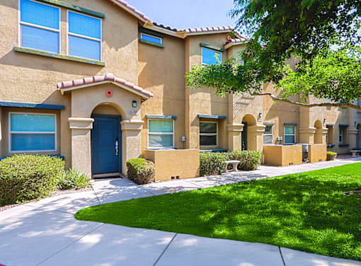 A row of houses with blue doors and windows.