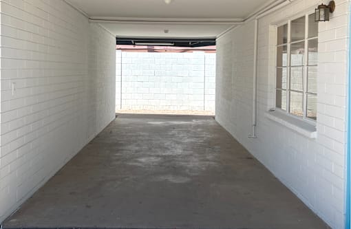 A white room with a window and a door.