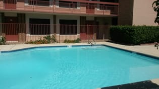 A small pool in front of a building at Ambassador West Apartments, Arizona