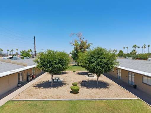 A sunny day at a residential complex with a clear blue sky.