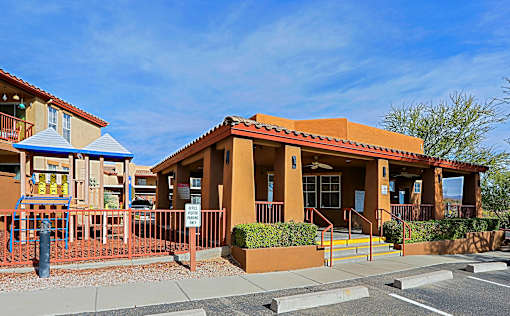 A building with a red roof and a blue awning is in the image.